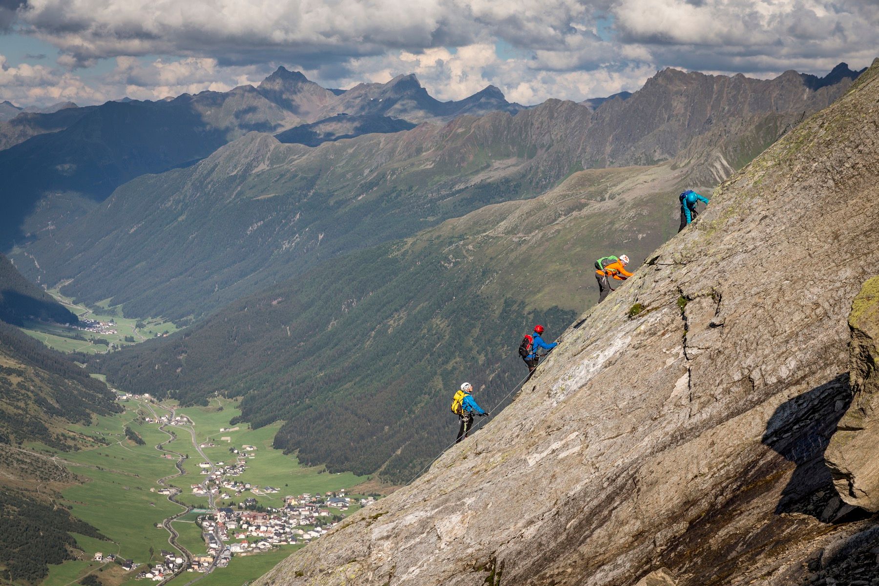 Via ferrata climbers on the wire rope on the north face of the Ballunspitze