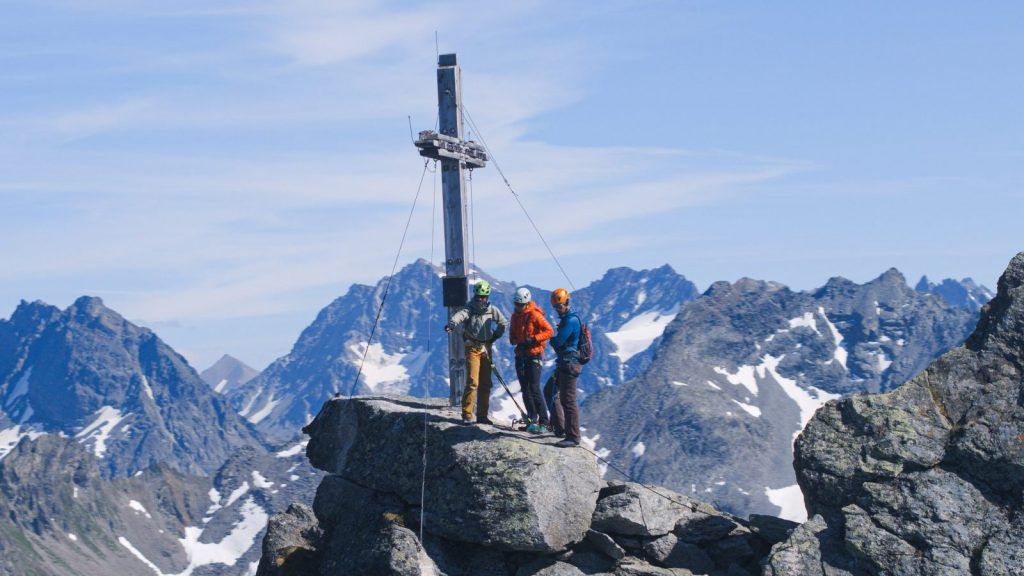 A via ferrata climber with a rucksack on the rock face