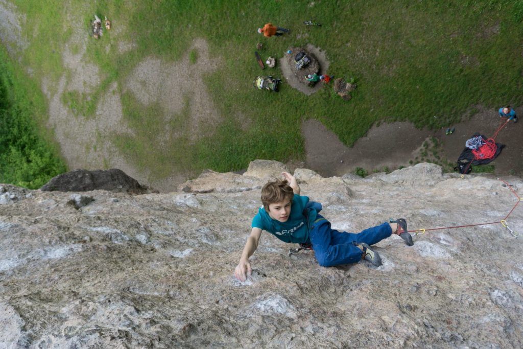 Child at a Rock Climbing Area, belayed by an adult