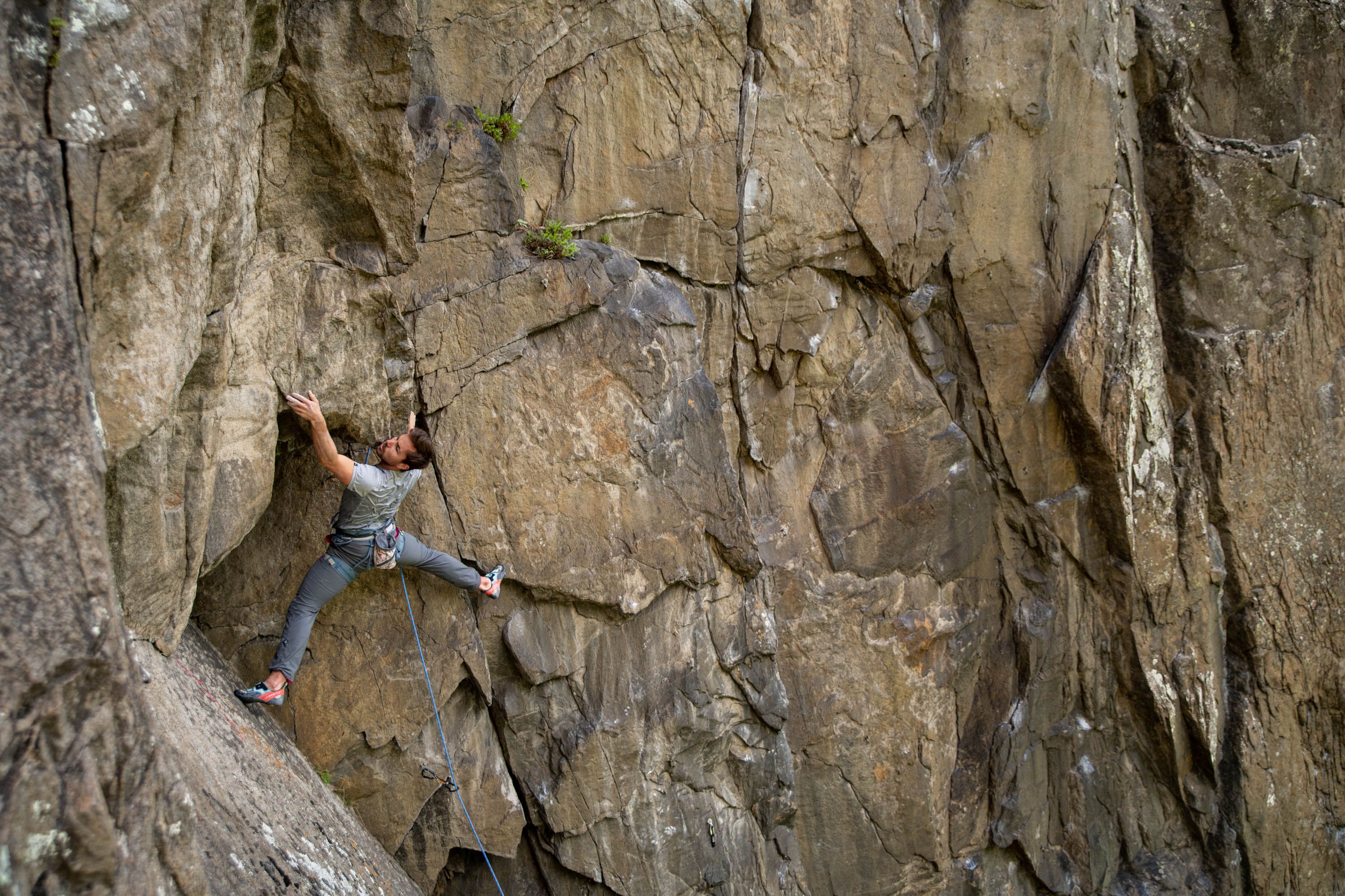Kletterer in einer Route an der rötlichen Gneiswand der Engelswand