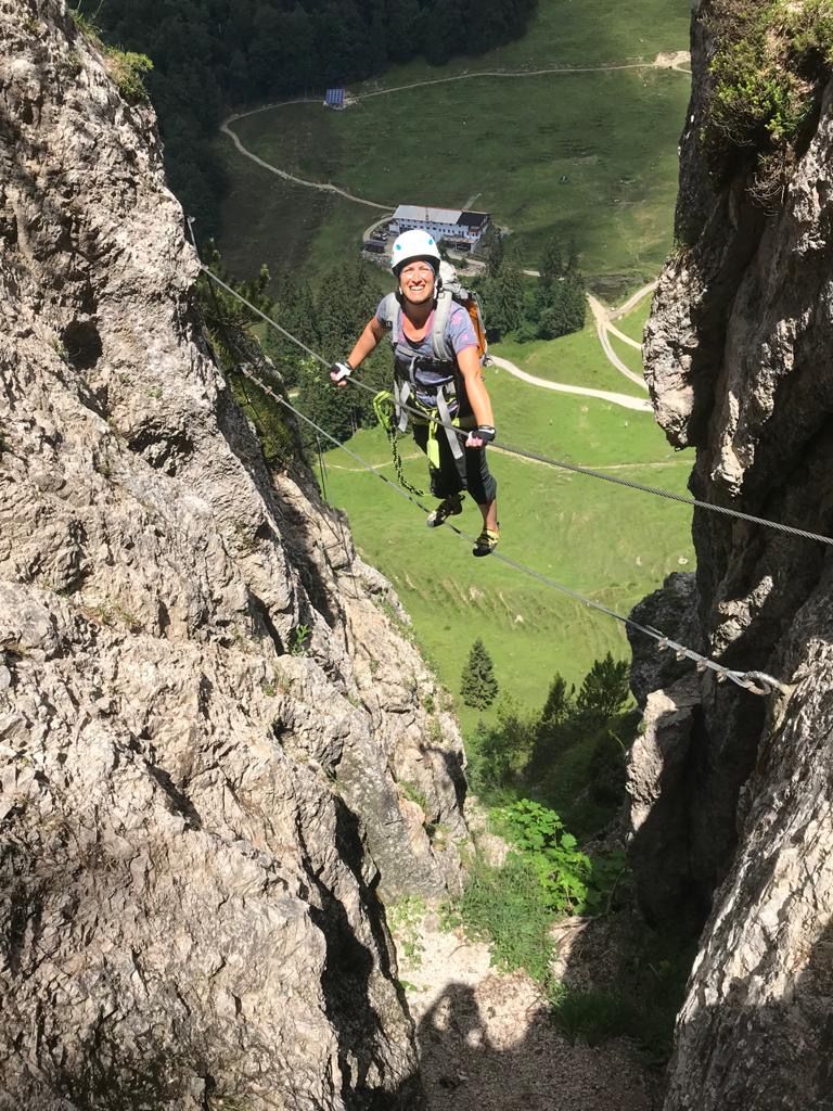 Female via ferrata climber on a rope bridge