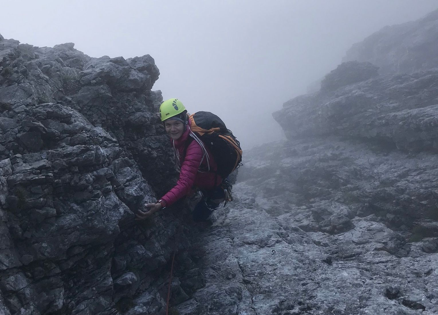 Aufziehende Wolken über einer alpinen Kletterwand