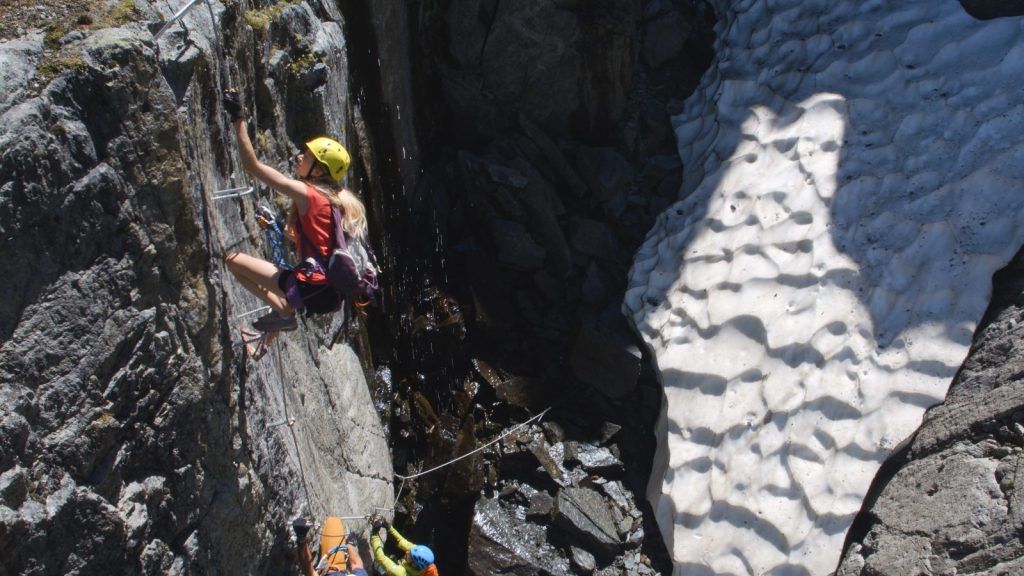 Via ferrata climbers wearing helmets and gloves