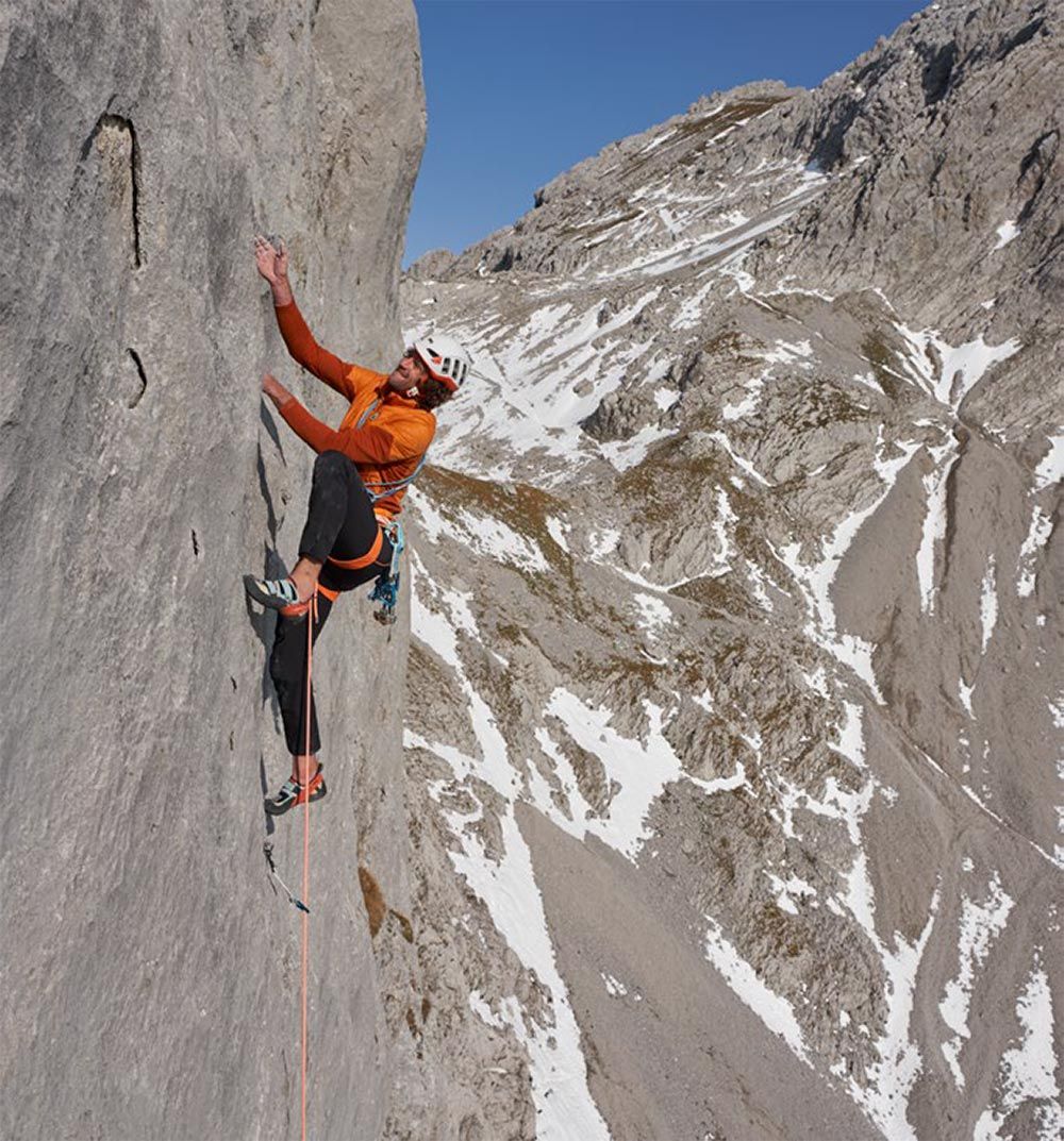 Climber on the steep crux section of the ‘Sportherz’ route in the Wilder Kaiser