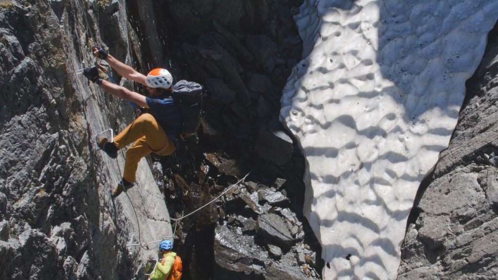 Via ferrata climbers on an overhanging D section