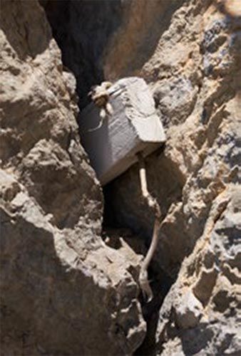 Old wooden wedges and protection used by the first ascenders in a crack