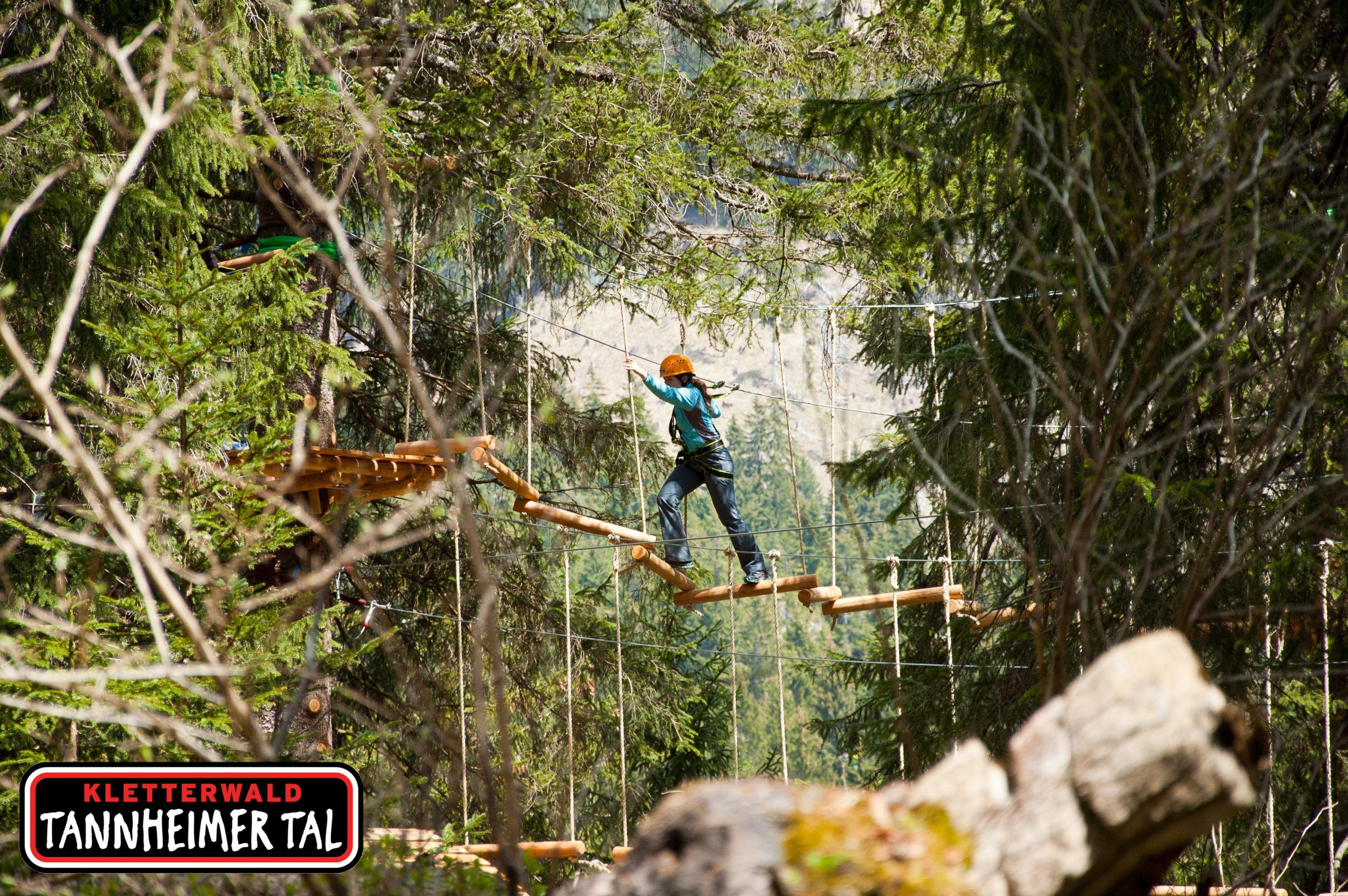 A child on the forest rope course in the Tannheim Valley