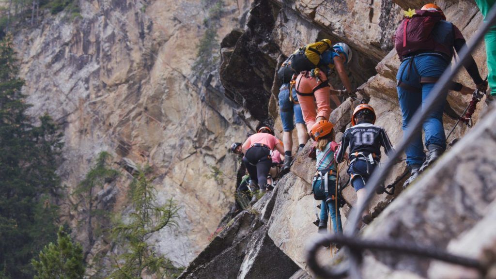 Two via ferrata climbers overtaking each other on the wire rope