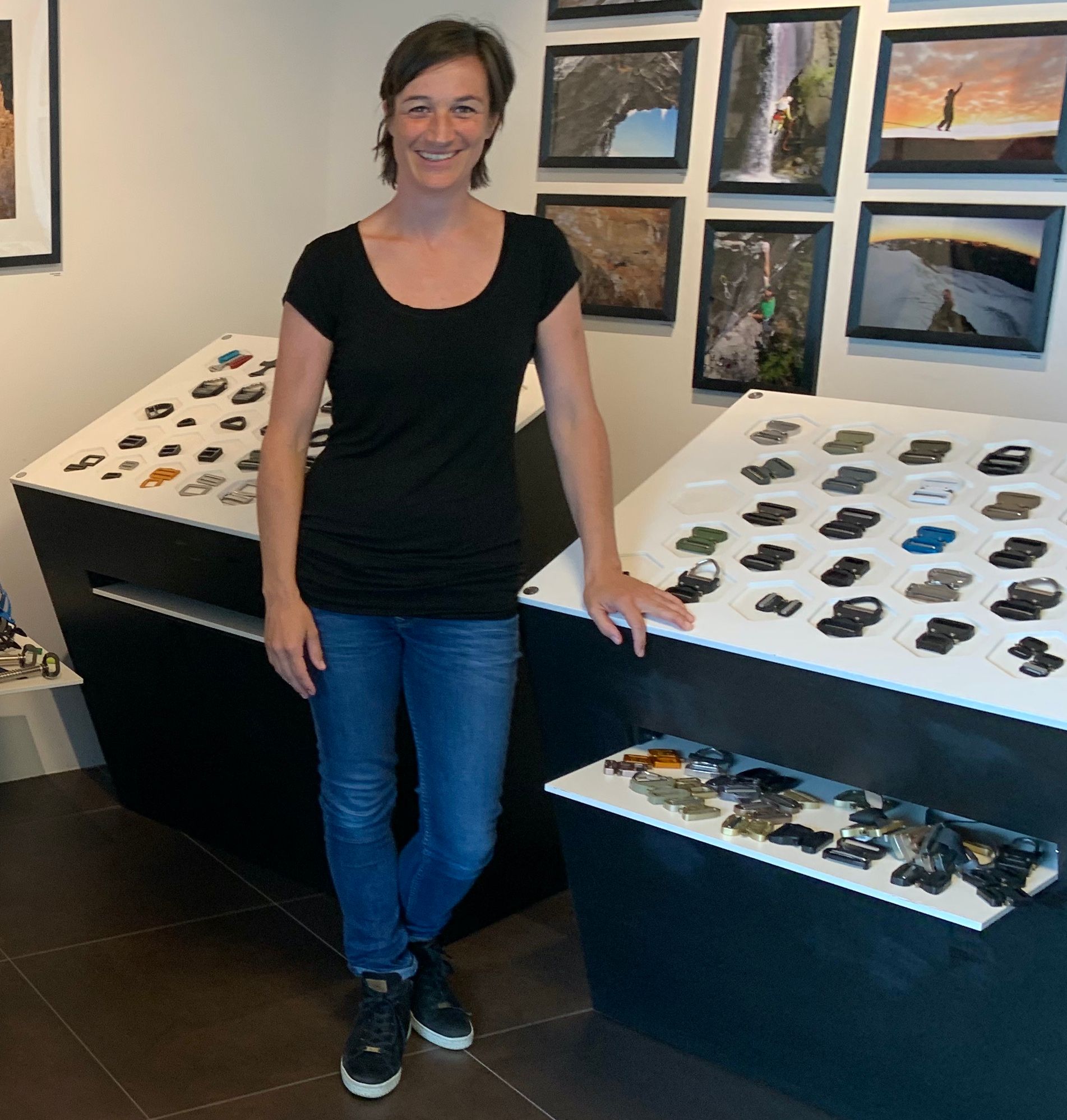 Katrin Mark-Winkler in front of shelves displaying Cobra buckles at AustriAlpin in Fulpmes