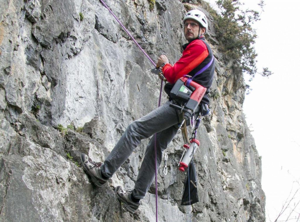 Route-setter drilling holes at the Walchenbach Rock Climbing Area