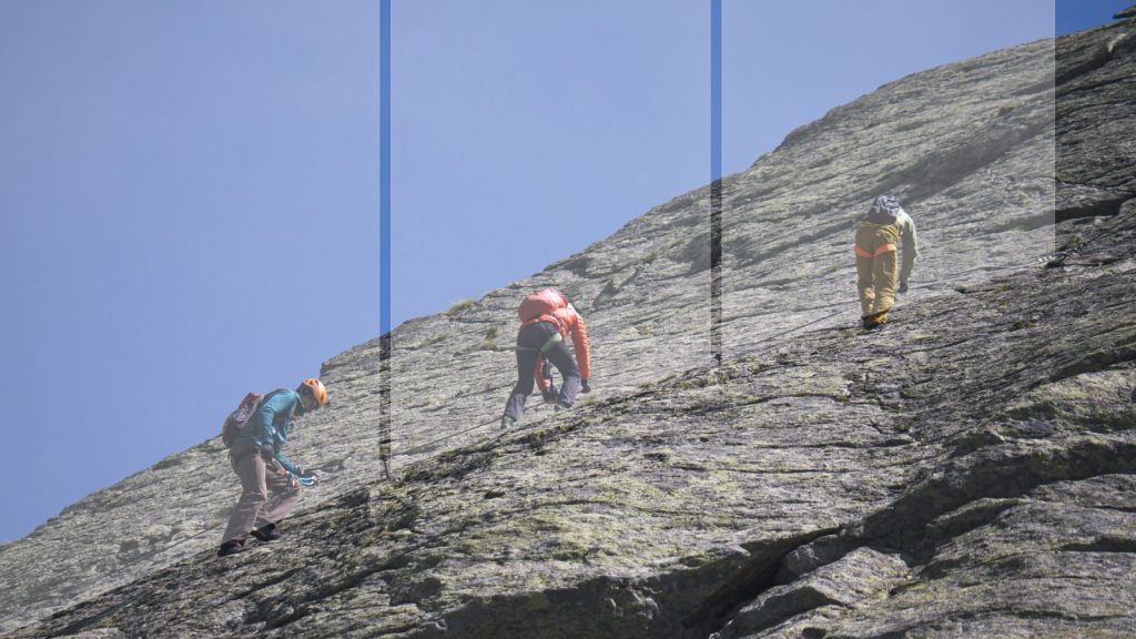 Two via ferrata climbers, spaced apart in separate sections