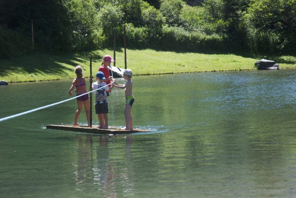 Stillebach swimming pond in the Pitztal valley, with a sunbathing area and views towards the Glacier Ski Resort