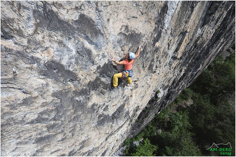 A female climber on a sunny Rock Face