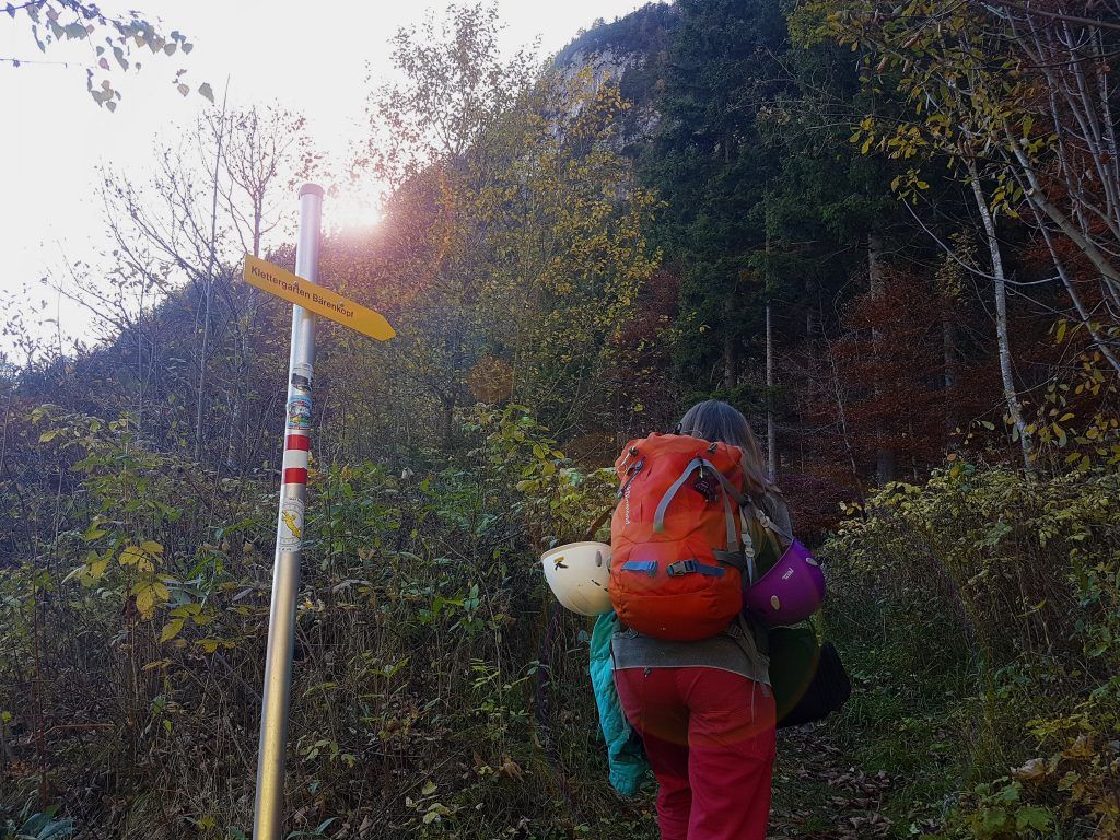 Kletterin mit Rucksack am Wegweiser zum Klettergarten Bärenkopf